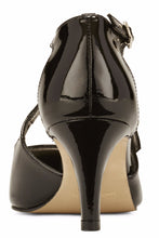 Back view of the Stella. A black patent leather high heel with two delicate straps that crisscross over the front. This two and a half inch heel has a pointed toe and two small buckles on the straps. Available in wide width and extra wide widths.