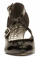 Front view of the Stella. A black patent leather high heel with two delicate straps that crisscross over the front. This two and a half inch heel has a pointed toe and two small buckles on the straps. Available in wide width and extra wide widths.
