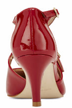Back view of the Stella. A red patent leather high heel with two delicate straps that crisscross over the front. This two and a half inch heel has a pointed toe and two small buckles on the straps. Available in wide width and extra wide widths.