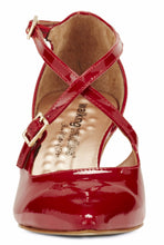 Front view of the Stella. A red patent leather high heel with two delicate straps that crisscross over the front. This two and a half inch heel has a pointed toe and two small buckles on the straps. Available in wide width and extra wide widths.